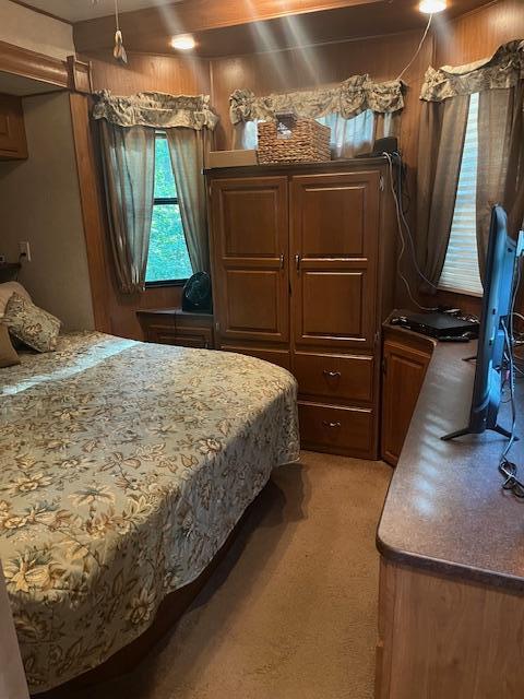 bedroom featuring light carpet