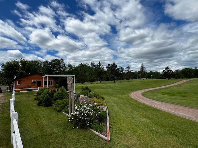 view of home's community with a yard