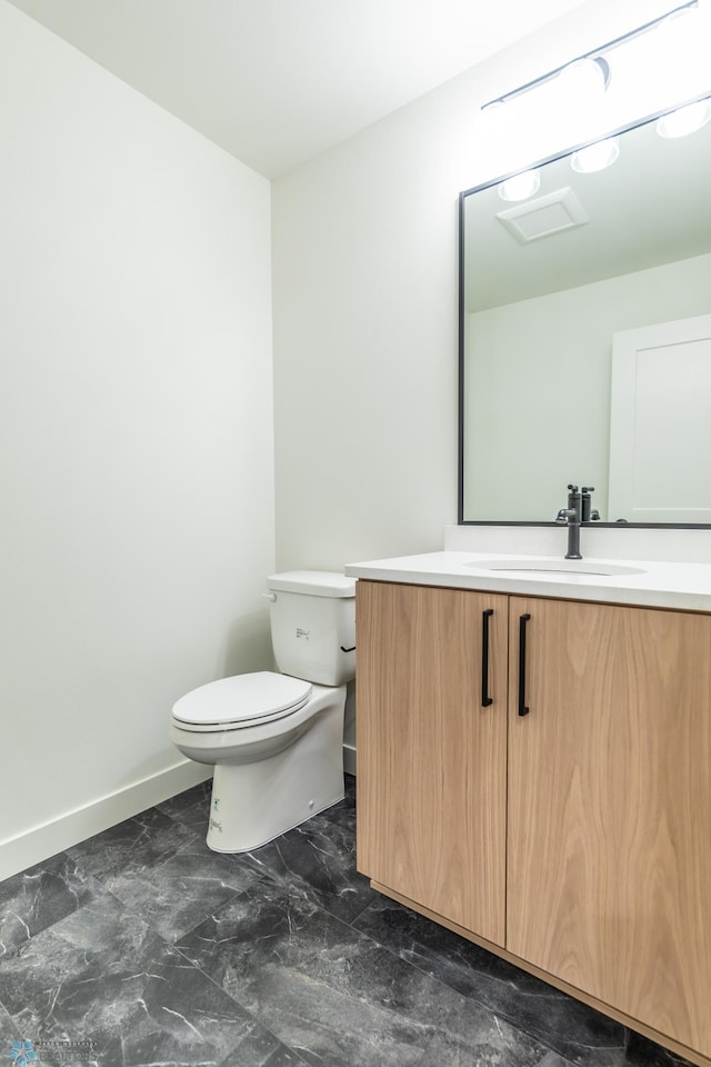 8030 59th St S, Horace, ND 58047 - half bathroom with toilet, vanity, marble finish floors, and baseboards