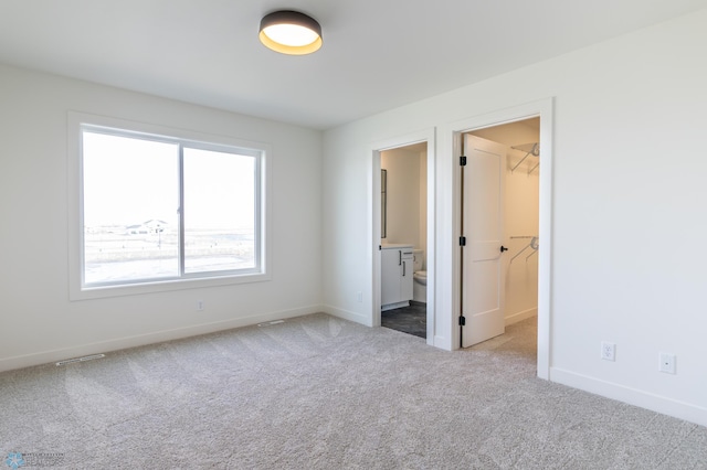 8030 59th St S, Horace, ND 58047 - unfurnished bedroom with carpet, baseboards, a spacious closet, and connected bathroom