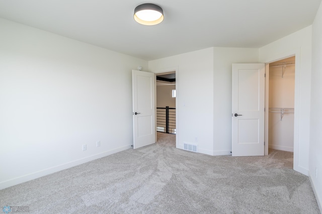 8030 59th St S, Horace, ND 58047 - unfurnished bedroom featuring carpet flooring, a spacious closet, baseboards, and a closet