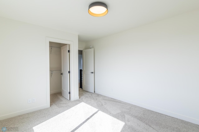 8030 59th St S, Horace, ND 58047 - unfurnished bedroom with light colored carpet, a spacious closet, baseboards, and a closet