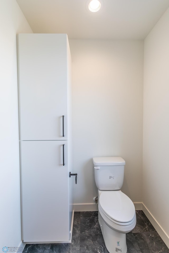 8030 59th St S, Horace, ND 58047 - bathroom with baseboards, marble look tile flooring, toilet, and recessed lighting