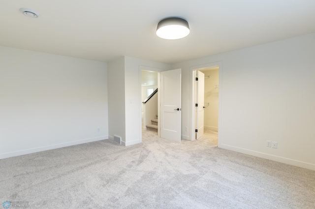 8030 59th St S, Horace, ND 58047 - spare room featuring light carpet, baseboards, and stairs