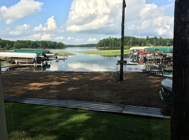 dock area with a water view and boat lift