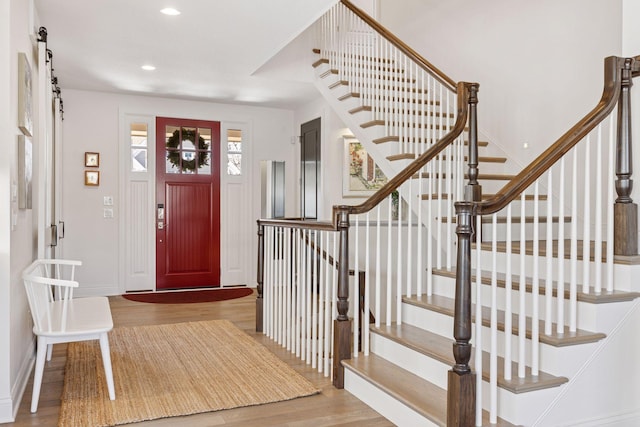 entrance foyer featuring stairway, baseboards, recessed lighting, and wood finished floors