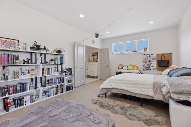 bedroom with recessed lighting and wood finished floors