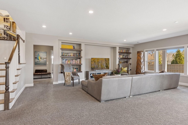 carpeted living area with stairs, recessed lighting, baseboards, and built in shelves
