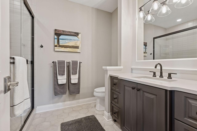 bathroom featuring vanity, toilet, baseboards, tile patterned floors, and a shower stall