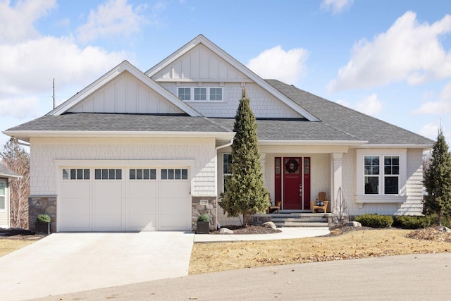 craftsman inspired home featuring a garage, stone siding, roof with shingles, board and batten siding, and concrete driveway