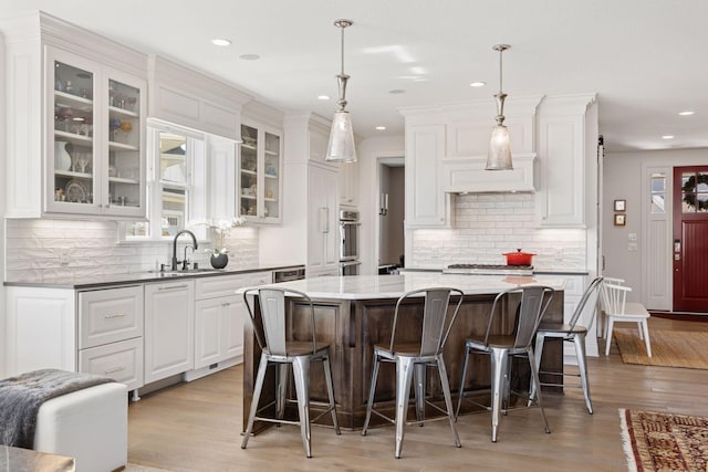 208 Byrondale Ave, Wayzata, MN 55391 - kitchen featuring a breakfast bar, white cabinets, backsplash, and recessed lighting