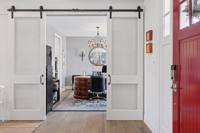 208 Byrondale Ave, Wayzata, MN 55391 - foyer with a barn door, wood finished floors, a chandelier, and baseboards