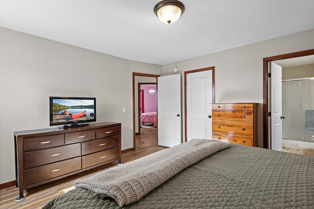 bedroom featuring baseboards and light wood finished floors