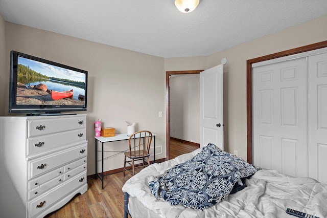 bedroom with a closet and light wood-style floors