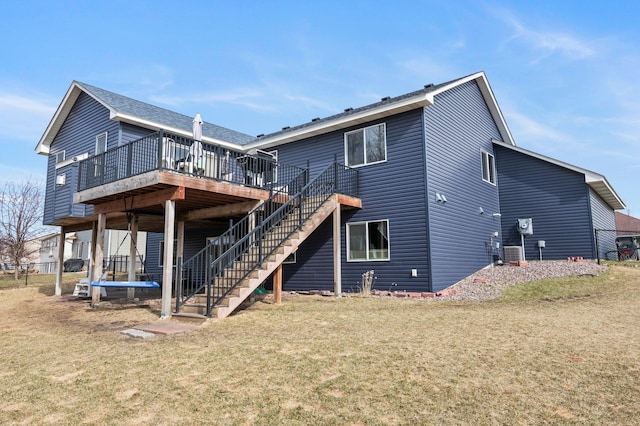 back of property with stairs, a lawn, central AC, and a deck