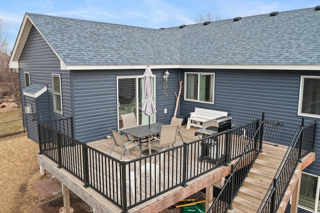 deck featuring stairway and outdoor dining area
