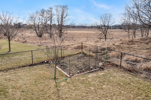 view of yard featuring a rural view and fence