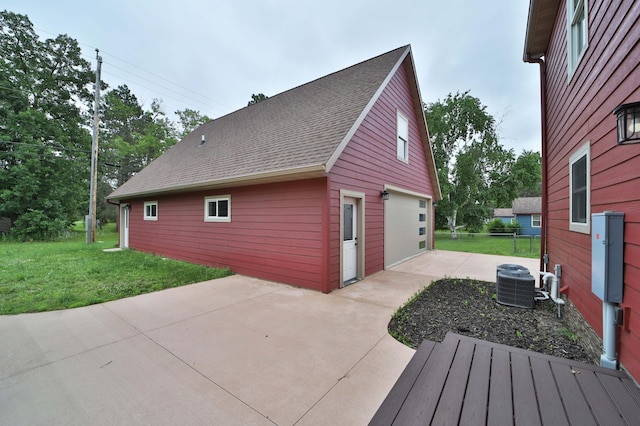 718 Main Ave N, Park Rapids, MN 56470 - view of side of home with a lawn, a patio area, and a detached garage