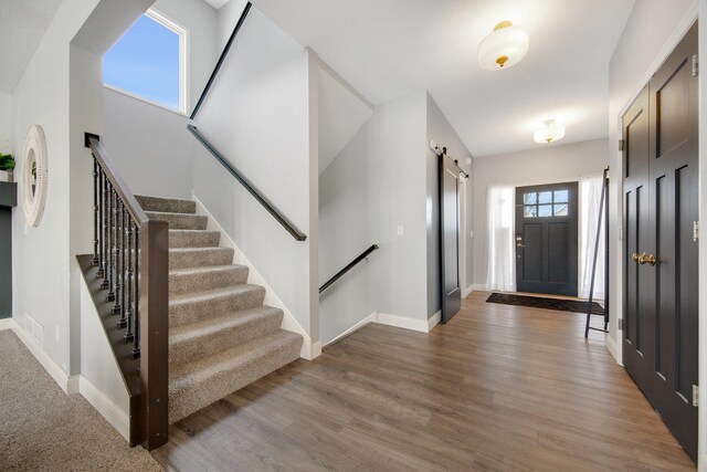 5204 Porchlight, Woodbury, MN 55129 - entrance foyer featuring stairs, a barn door, and light wood finished floors
