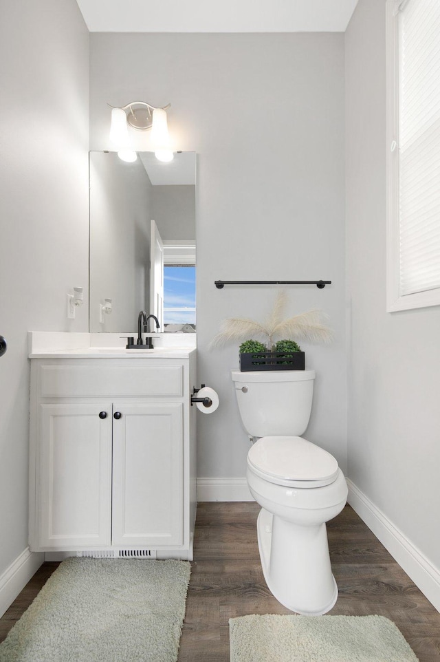 5204 Porchlight, Woodbury, MN 55129 - half bath with vanity, toilet, wood finished floors, and baseboards