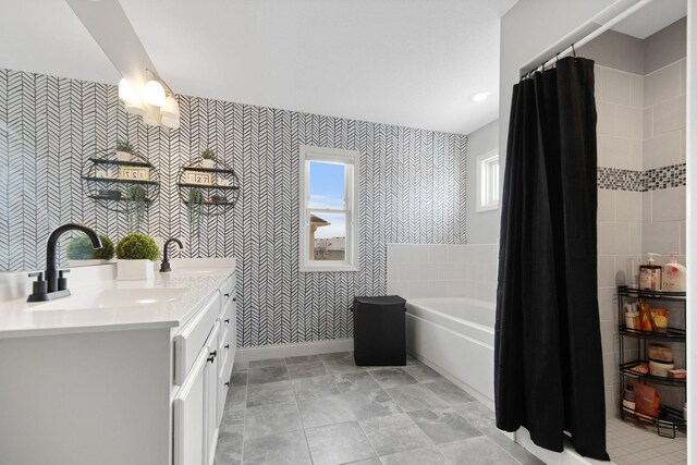 5204 Porchlight, Woodbury, MN 55129 - bathroom featuring a sink, baseboards, double vanity, and a washtub