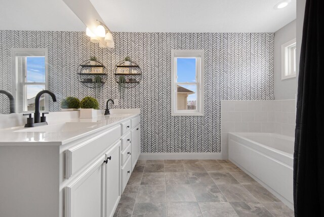 5204 Porchlight, Woodbury, MN 55129 - bathroom with a sink, a healthy amount of sunlight, a bath, and double vanity