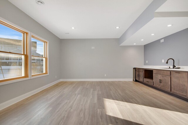 5204 Porchlight, Woodbury, MN 55129 - bar with recessed lighting, light wood-type flooring, baseboards, and a sink