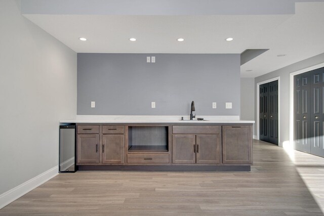 5204 Porchlight, Woodbury, MN 55129 - kitchen with baseboards, light countertops, light wood-style floors, and a sink