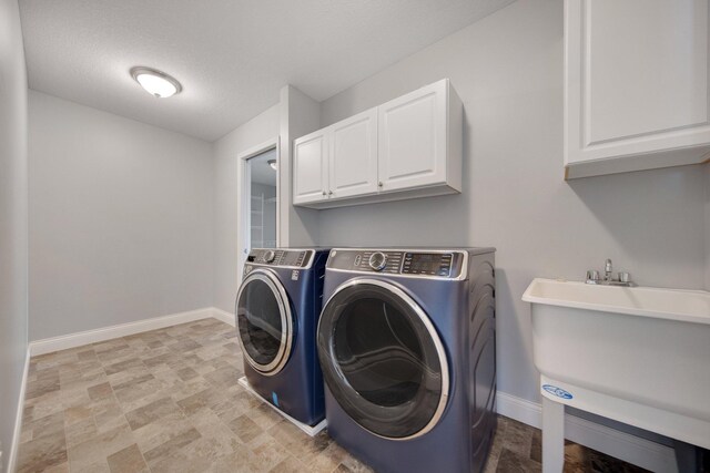 5204 Porchlight, Woodbury, MN 55129 - laundry area featuring a sink, baseboards, cabinet space, and washing machine and dryer