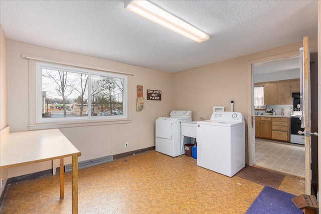 washroom featuring laundry area, a healthy amount of sunlight, visible vents, and separate washer and dryer