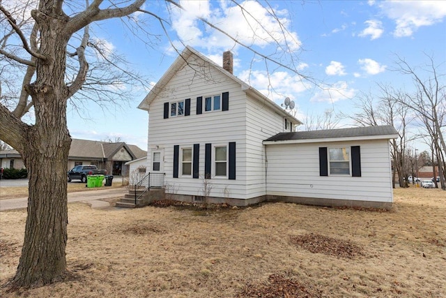 view of front of house featuring a chimney