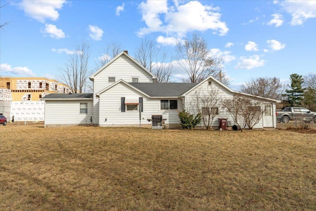 back of property featuring a yard