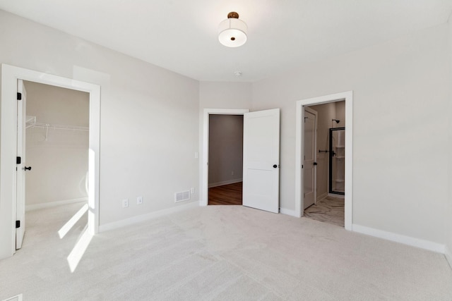 10071 Arrowwood Trl, Woodbury, MN 55129 - unfurnished bedroom with a walk in closet, carpet floors, a closet, and ensuite bathroom