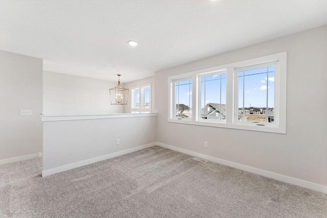 10071 Arrowwood Trl, Woodbury, MN 55129 - spare room with a chandelier, carpet flooring, and recessed lighting