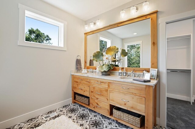 16999 Dakota St NW, Andover, MN 55304 - full bath with double vanity, baseboards, and a sink