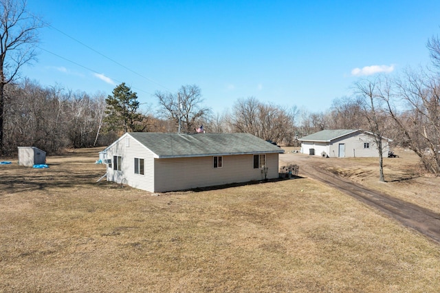 27928 Verdin St NW, Isanti, MN 55040 - view of side of property with an outdoor structure, a garage, and a lawn