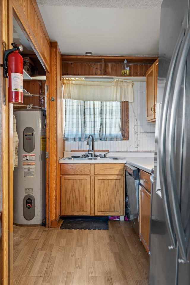27928 Verdin St NW, Isanti, MN 55040 - kitchen featuring light countertops, water heater, stainless steel appliances, a sink, and light wood-style floors