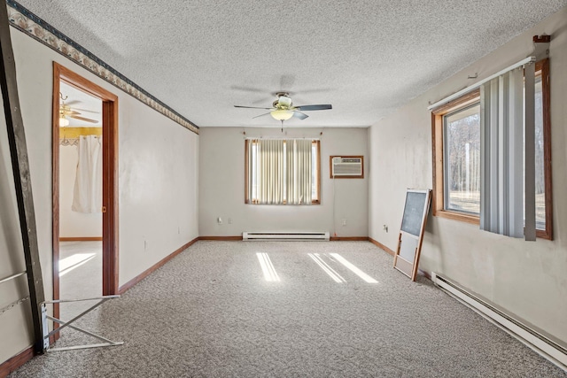 27928 Verdin St NW, Isanti, MN 55040 - carpeted spare room with ceiling fan, a wall unit AC, and a baseboard heating unit