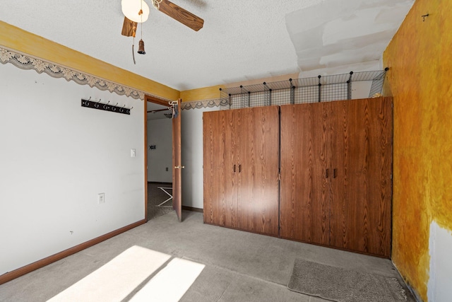 27928 Verdin St NW, Isanti, MN 55040 - unfurnished bedroom featuring baseboards, a textured ceiling, ceiling fan, and carpet