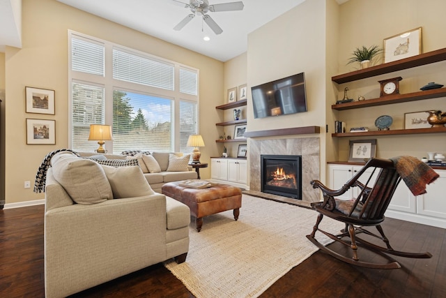 8127 Virginia Pl, Savage, MN 55378 - living area featuring dark wood-style flooring, ceiling fan, a fireplace, built in shelves, and a high ceiling
