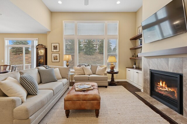 8127 Virginia Pl, Savage, MN 55378 - living room with a high end fireplace, recessed lighting, a towering ceiling, dark wood-style flooring, and baseboards
