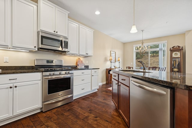 8127 Virginia Pl, Savage, MN 55378 - kitchen featuring stainless steel appliances, a sink, a chandelier, dark wood-style floors, and white cabinets