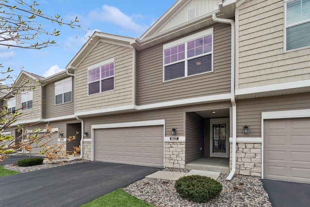 8127 Virginia Pl, Savage, MN 55378 - multi unit property featuring an attached garage, driveway, and stone siding