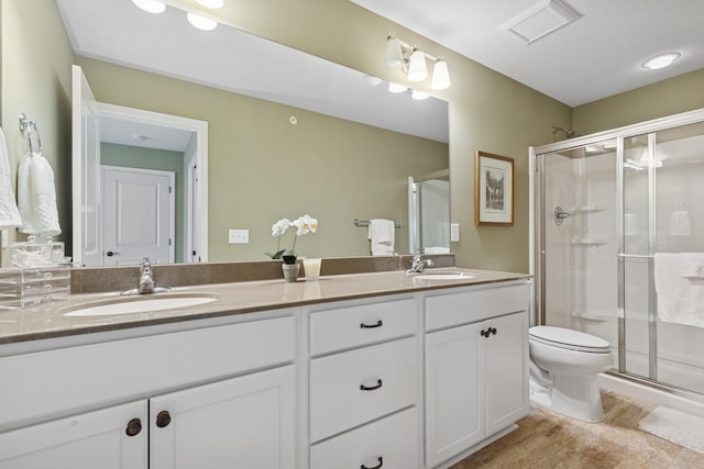 8127 Virginia Pl, Savage, MN 55378 - bathroom featuring a shower stall, double vanity, and toilet