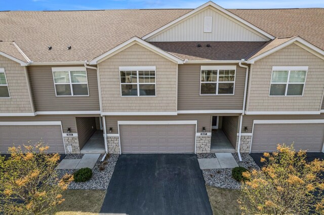 8127 Virginia Pl, Savage, MN 55378 - multi unit property featuring an attached garage, stone siding, a shingled roof, and driveway