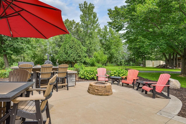 10069 Stacy Trl, Chisago City, MN 55013 - view of patio / terrace with an outdoor fire pit, outdoor dining space, and view of scattered trees