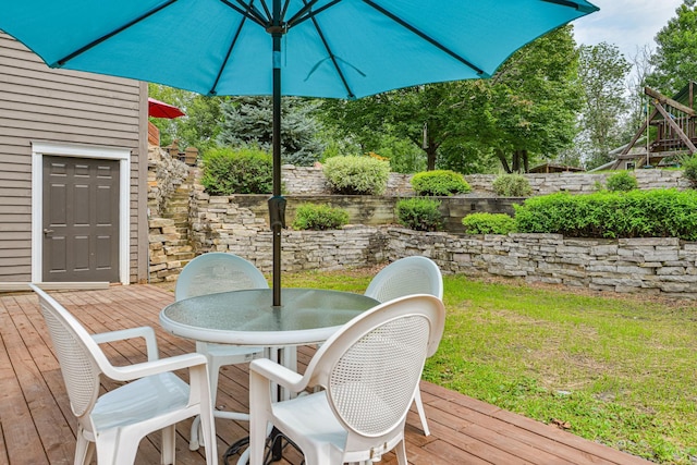 10069 Stacy Trl, Chisago City, MN 55013 - wooden deck featuring outdoor dining space and a yard