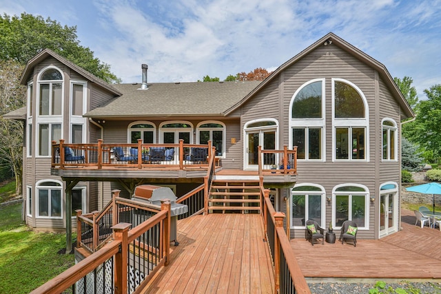 10069 Stacy Trl, Chisago City, MN 55013 - back of house with a wooden deck, roof with shingles, and stairway