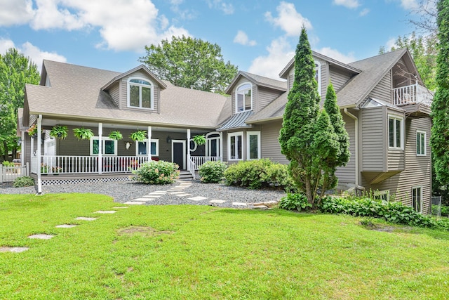 10069 Stacy Trl, Chisago City, MN 55013 - back of property featuring a porch, a yard, a shingled roof, and a balcony