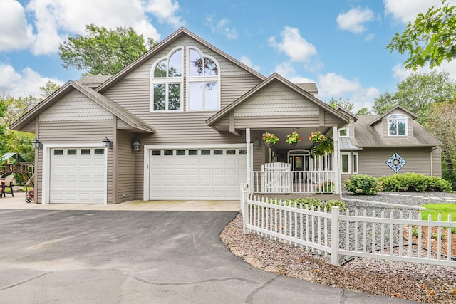 10069 Stacy Trl, Chisago City, MN 55013 - view of front facade featuring driveway, an attached garage, a porch, and fence